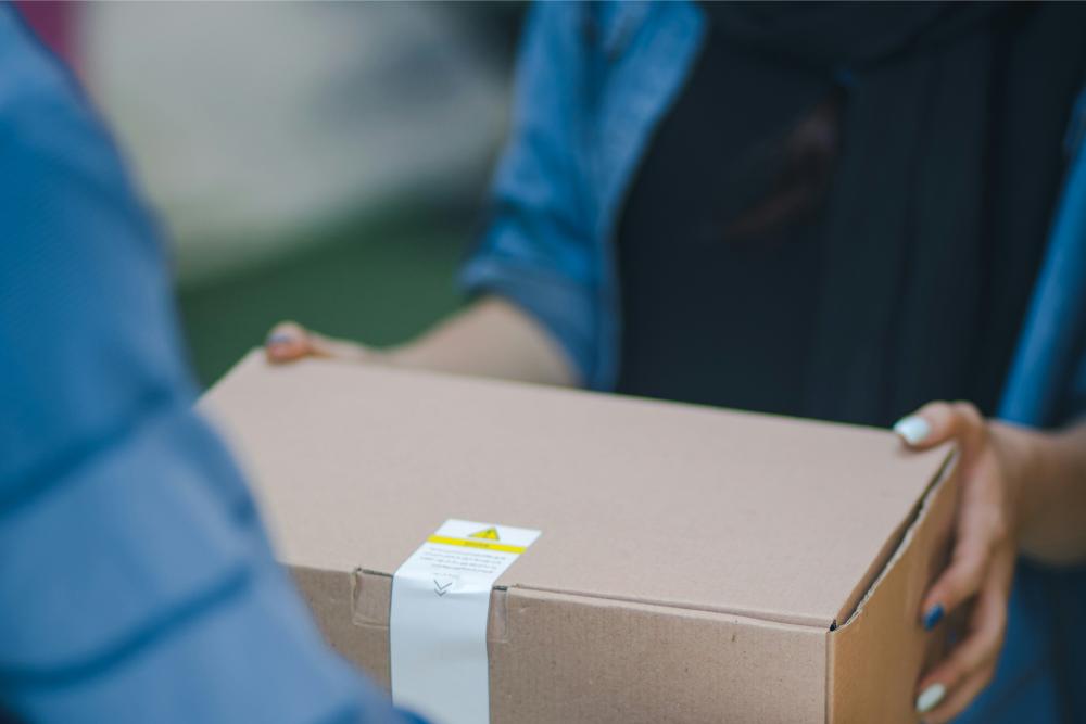 a person holding a cardboard box